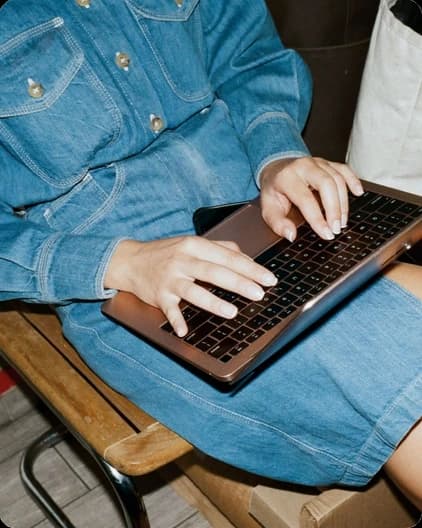 A colleague typing on a laptop