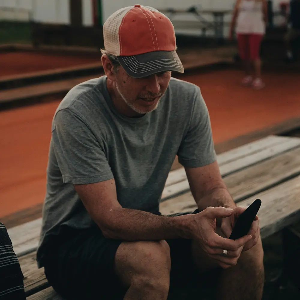 Coach reviewing client leads on their phone – tips to increase sales call bookings.