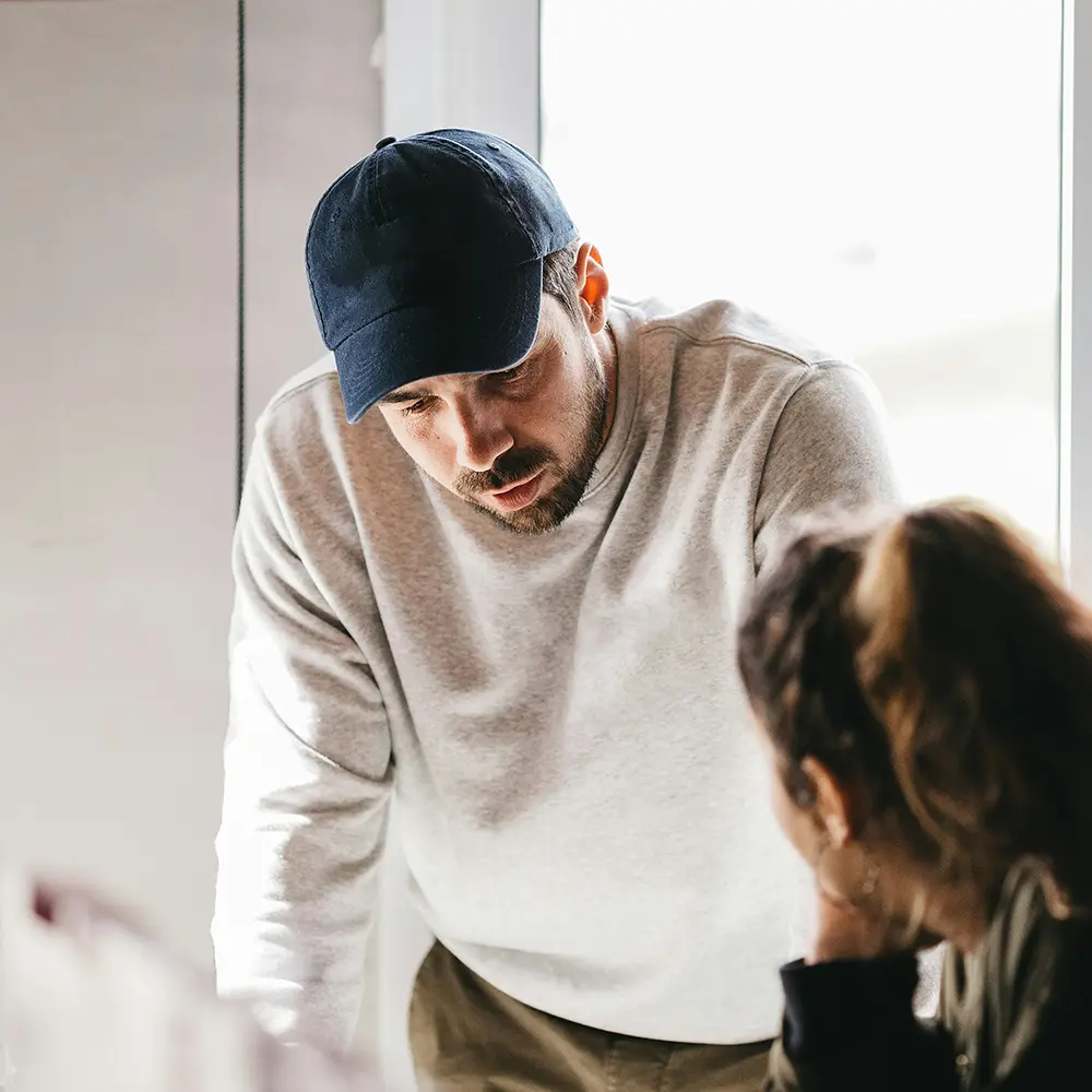 Coach talking to a client – navigating the decision between personal and group coaching formats.