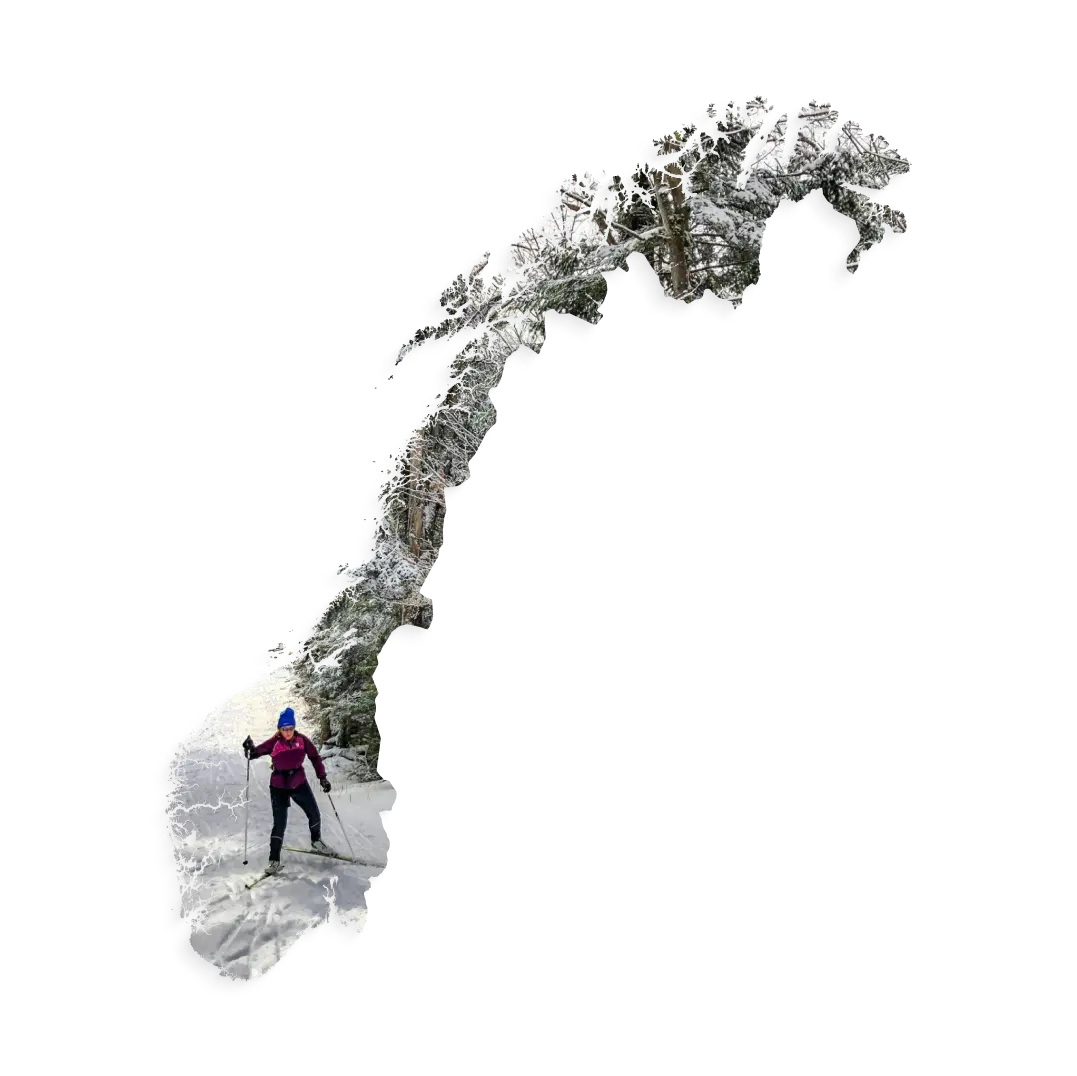 Aerial view of Norway's snowy landscape with a man skiing through pristine white snow in the background showcasing the CoCoach presence in Norway.